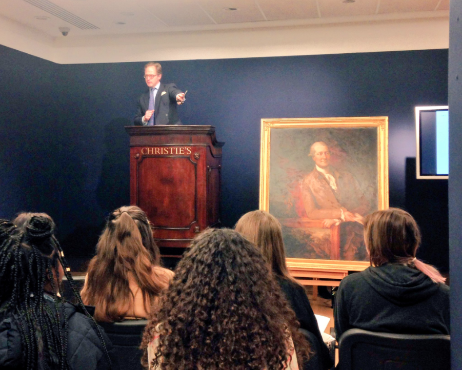 Students participate in a mock auction at Christie's Auction House