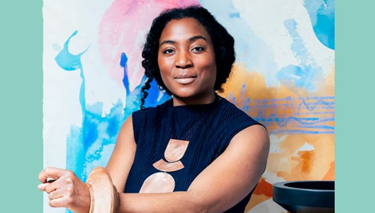 Simone Brewster wearing a blue top smiling